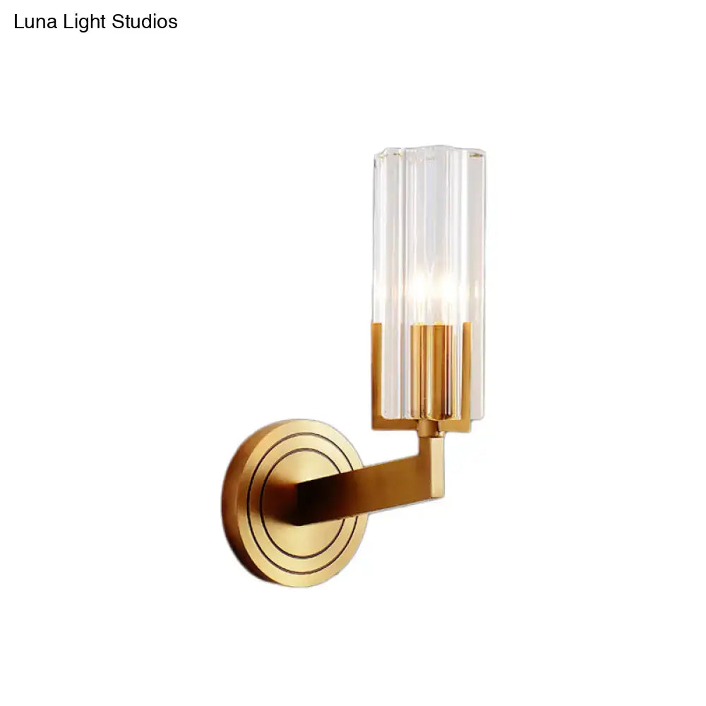 Gold-toned retro brass wall lamp with clear vertically ribbed glass shade and circular decorative backplate inches wide