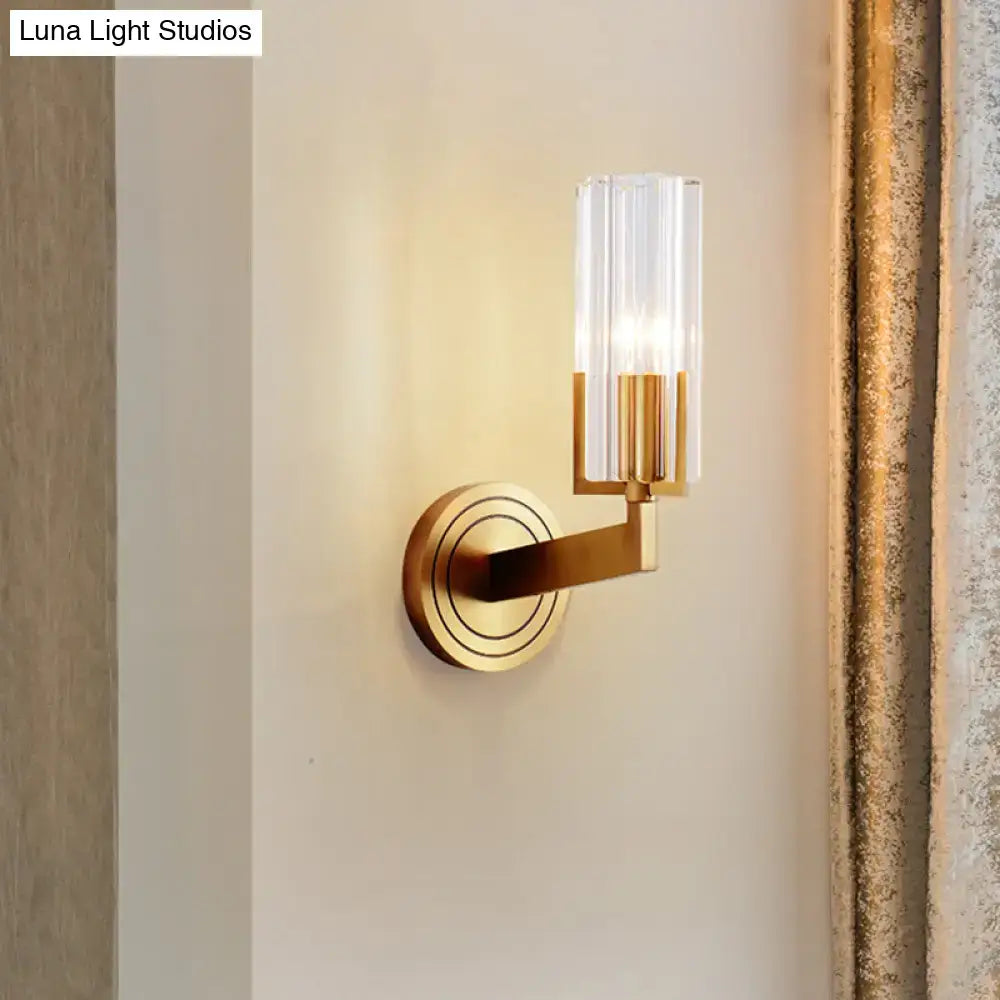 A modern retro brass wall lamp with gold-toned finish and cylindrical ribbed glass shade 8 inches wide for living room use