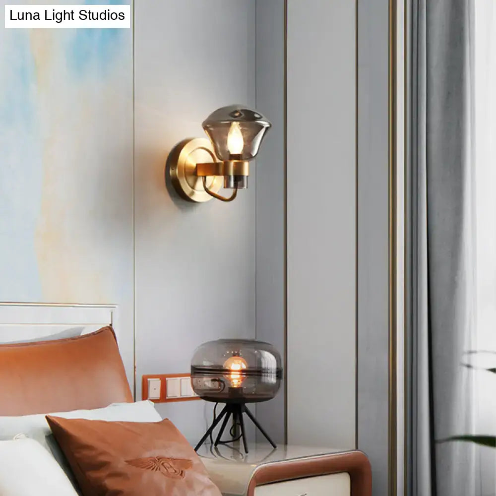 Brass-finished wall sconce light fixture with smoke gray amber glass shade for bedroom retro decor