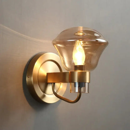 Brass-finished retro bedroom wall light fixture with smoke gray amber glass shade and exposed bulb sconce