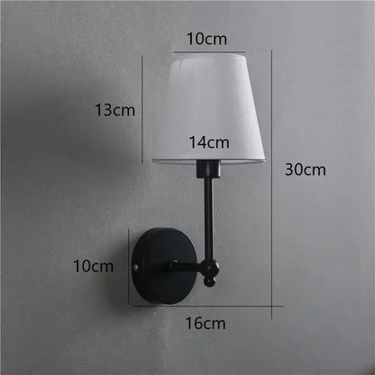 Black metal wall lamp with white fabric lampshade featuring a gold led retro style for bedroom use