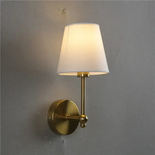 Brass-finished wall lamp with gold led retro design and tapered white fabric shade for bedroom sconce lighting