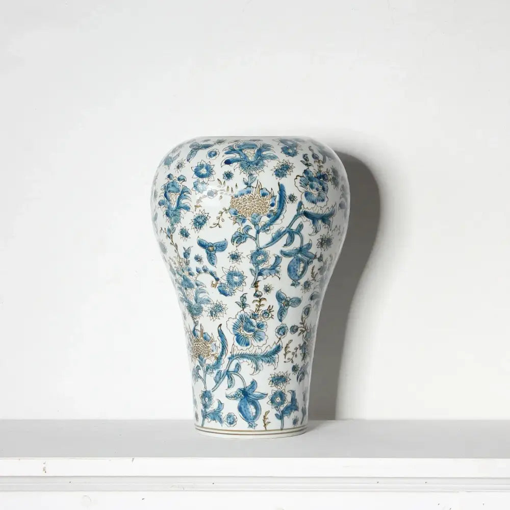 A white porcelain ceramic vase with intricate blue and gold floral patterns ideal for living room decorbites blue set