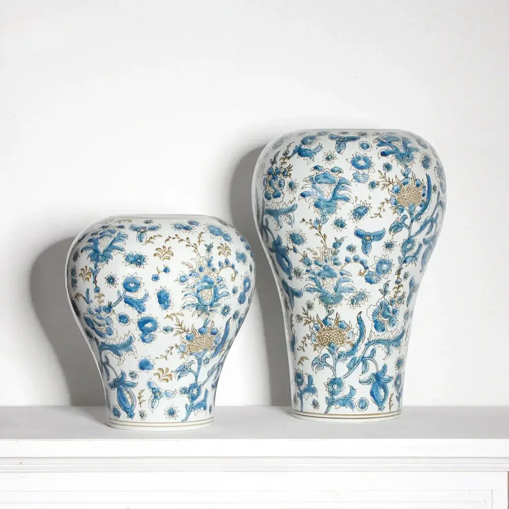 Two elegant white porcelain ceramic vases with blue floral patterns and gold accents by decorbites blue for living room decor