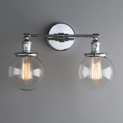 Chrome-finished retro double glass ball globe wall light with two spherical globes featuring exposed filament bulbs