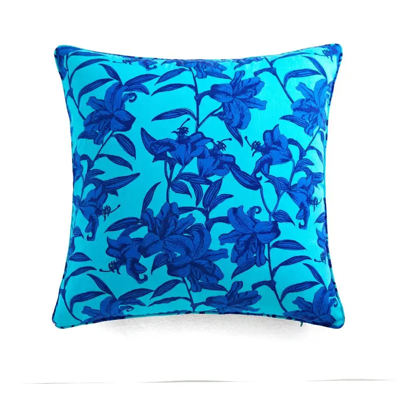 Vibrant turquoise retro circus throw pillow cover with bold dark blue lily floral pattern and cream tassels decorbites circus retro