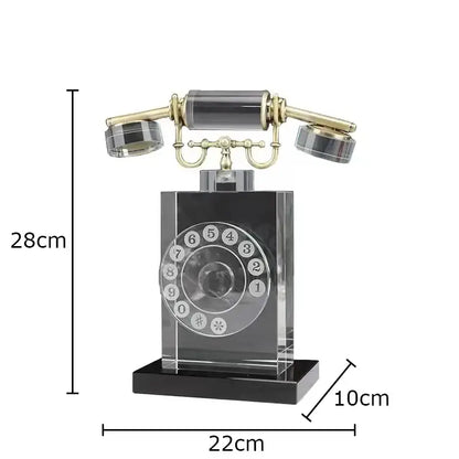 A sleek transparent crystal telephone sculpture with gold accents and black base for retro office desk decor