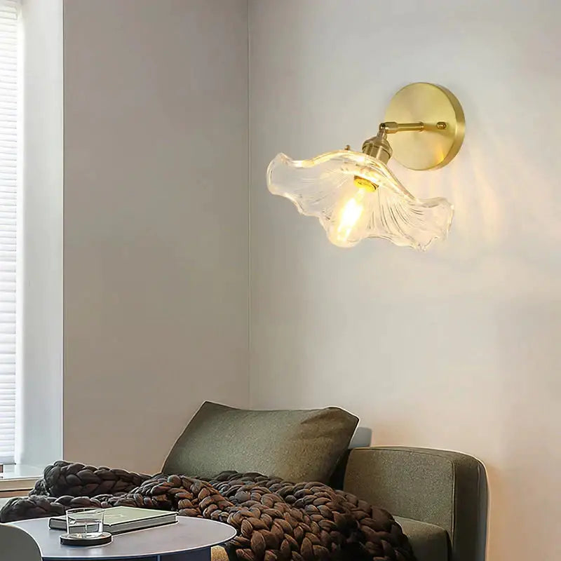A retro copper flower brass wall sconce with a delicate translucent fluted glass lampshade for bedroom lighting