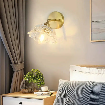 Gold-toned retro copper flower brass wall sconce with a delicate translucent fluted glass shade featuring leaf pattern