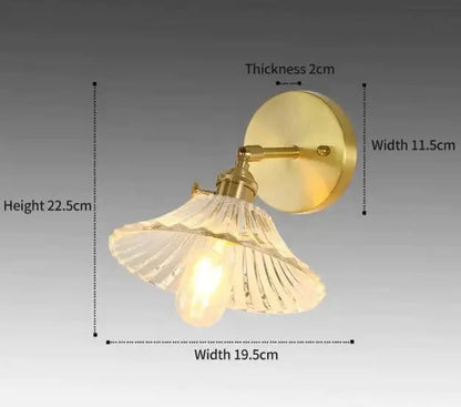 Retro copper flower brass wall sconce with gold-toned finish and clear fluted glass shade for bedroom lighting
