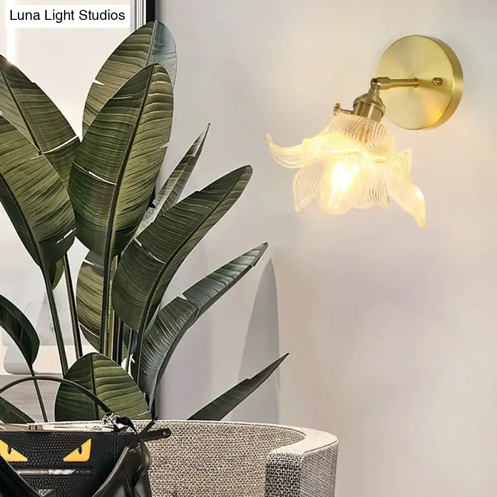Gold-toned retro copper flower brass wall sconce with a delicate translucent fluted glass shade for bedroom use