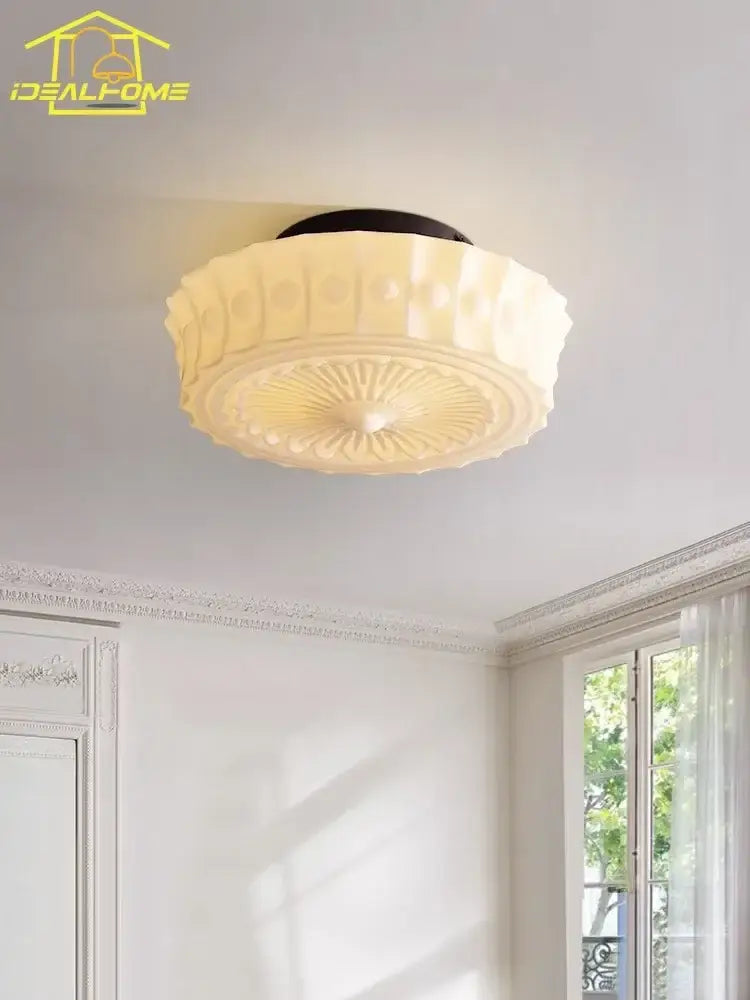 Cream decorbites glass led ceiling light with black base and textured radial pattern for bedroom decor