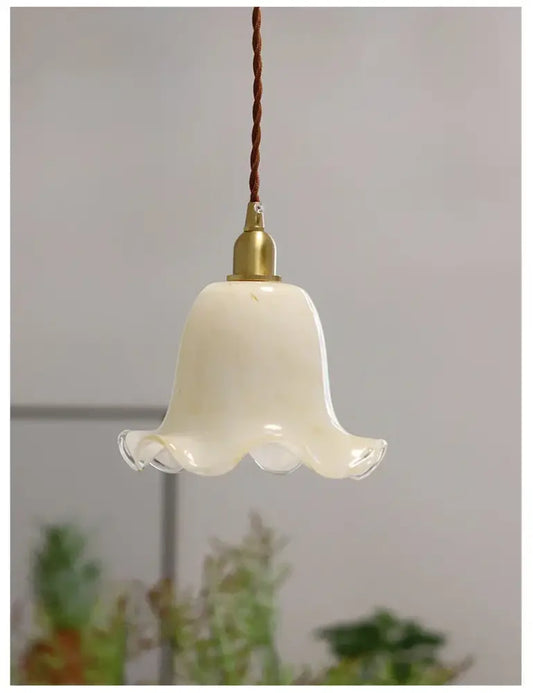Cream-colored glass led pendant lamp with brass finish and twisted brown cord for kitchen lighting