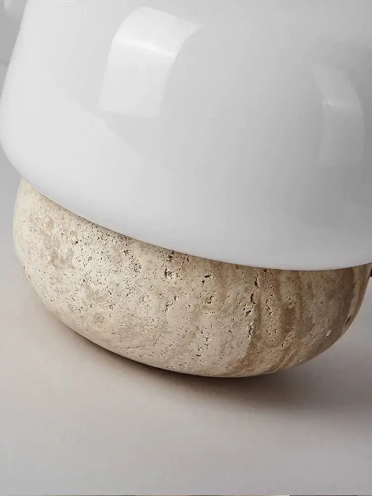 A sleek cream mushroom table lamp with a white ceramic shade on a textured beige stone base for decorbites cream mushroom decor