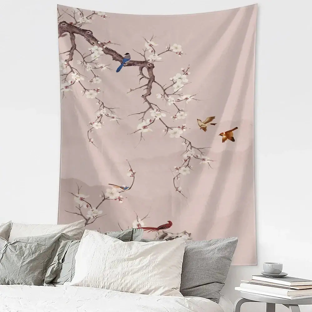 A soft pink wall tapestry with white blossoms and birds in flight featuring decorbites flying crane design