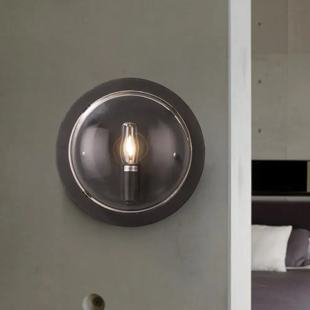 Retro dark gray metal wall sconce with clear glass shade and exposed filament bulb for living room lighting
