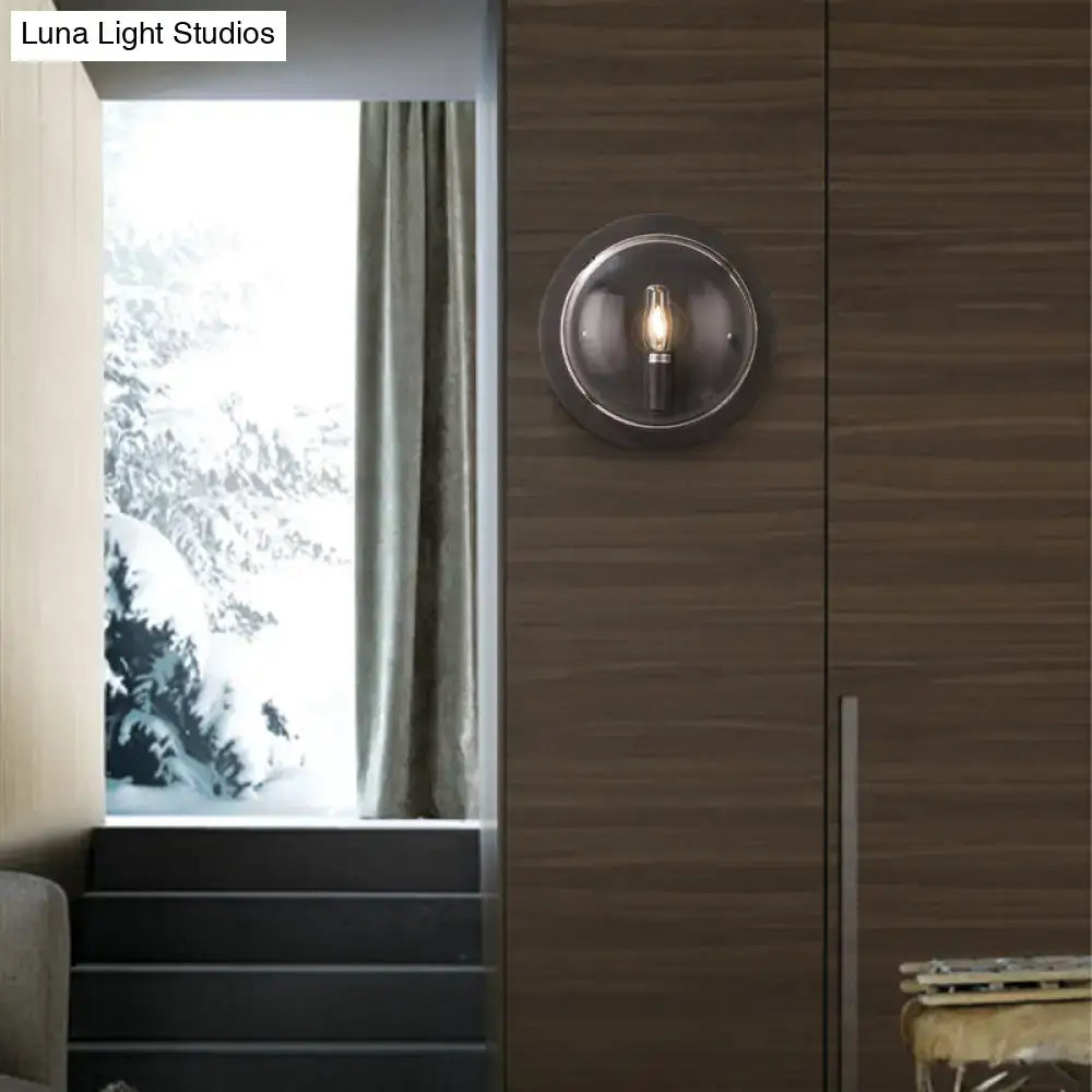 Retro dark gray metal wall sconce with clear glass shade and exposed filament bulb for living room lighting