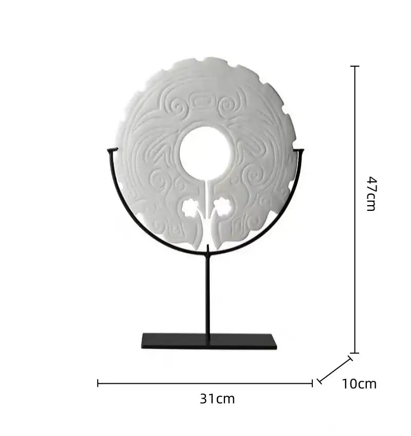 A white intricately carved circular geometric totem resin statue on a black stand for retro living room decorbites decor