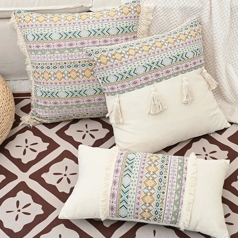 Three pastel pink green beige cushion covers with intricate geometric patterns and decorbites handmade tassel edges
