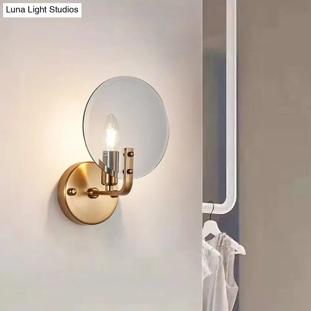 Retro gold and blue glass sconce light with gold toned circular mirrored shade and exposed bulb wall lighting fixture