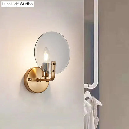 Retro gold and blue glass sconce light with gold toned circular mirrored shade and exposed bulb wall lighting fixture