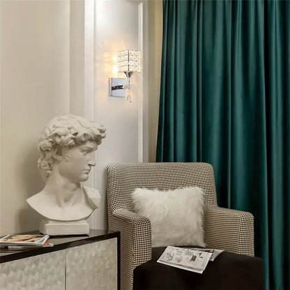 White marble bust of david with detailed curly hair as decorbites crystal wall sconce for living room lighting