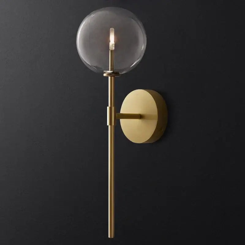 Retro gold wall sconce with a clear glass ball and minimalist design ideal for living room lighting