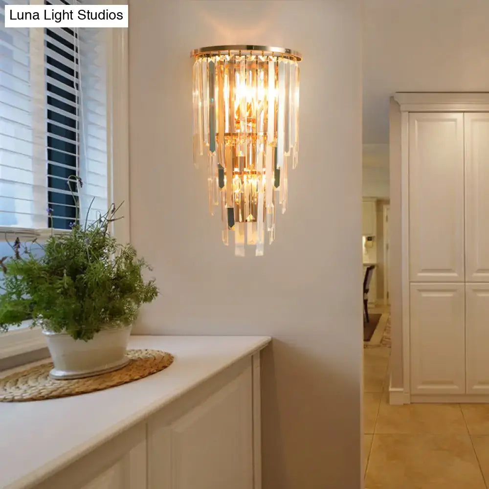 Retro gold wall mounted sconce with three lights featuring direct wired electric and cascading crystal prisms