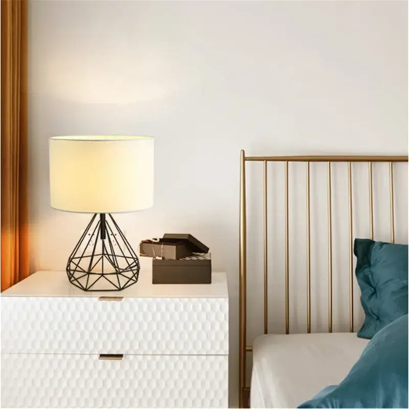 Black metal geometric table lamp with cream fabric shade perfect for study room lighting and decor