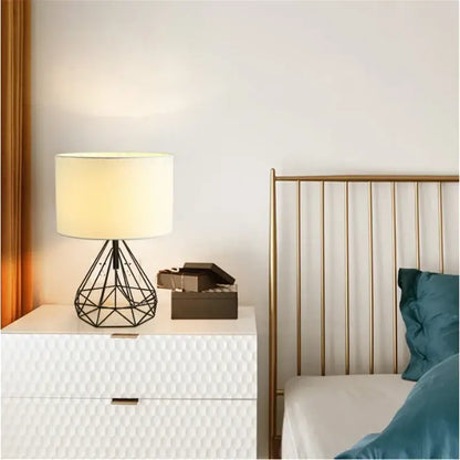 Black metal geometric table lamp with cream fabric shade perfect for study room lighting and decor