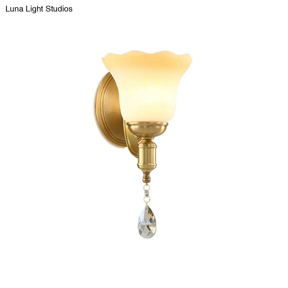 Retro gold wall lamp with blossom opaque glass shade and crystal teardrop for elegant bedroom lighting