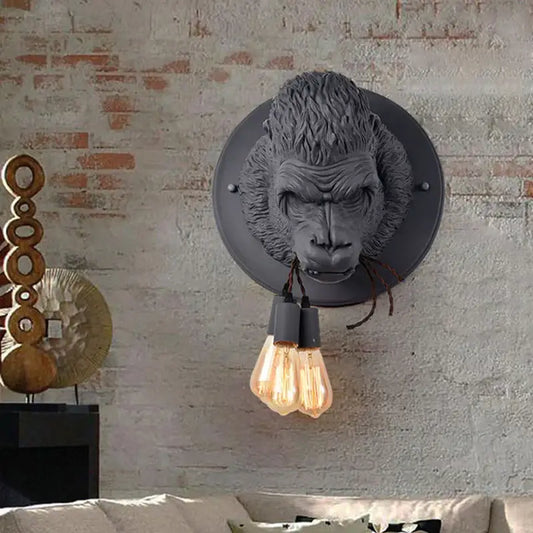 Gray gorilla resin wall lamp with two exposed filament bulbs by decorbites for retro bedroom lighting