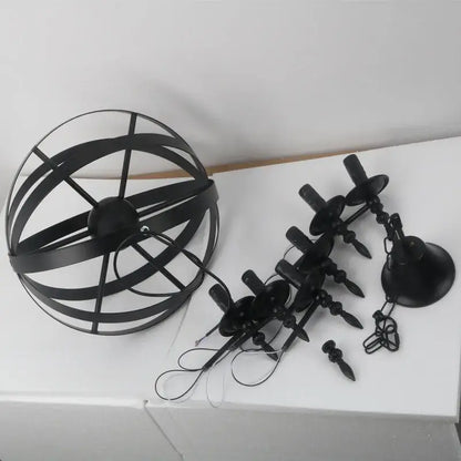 Black metal spherical decorbites iron chandelier with candle-style lights hanging by chains for dining room use