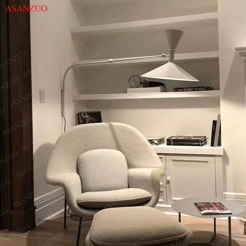 Cream-colored plush armchair with matching ottoman complementing retro industrial black and white dual arm wall lamps decorbites american retro