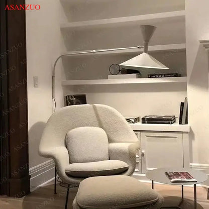 Cream-colored plush armchair with matching ottoman complementing retro industrial black and white dual arm wall lamps decorbites american retro