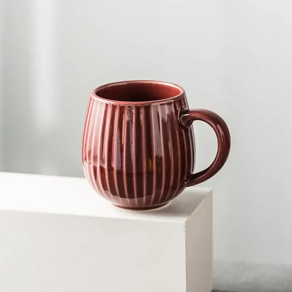 Glossy deep red ceramic coffee mug with vertical ridges and rounded handle featuring retro japanese gradient glaze