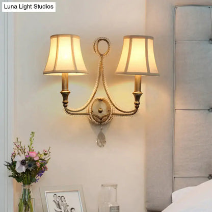 Retro loft fabric aged silver wall light with gold-toned ornate design, two cream fabric shades, and crystal accent