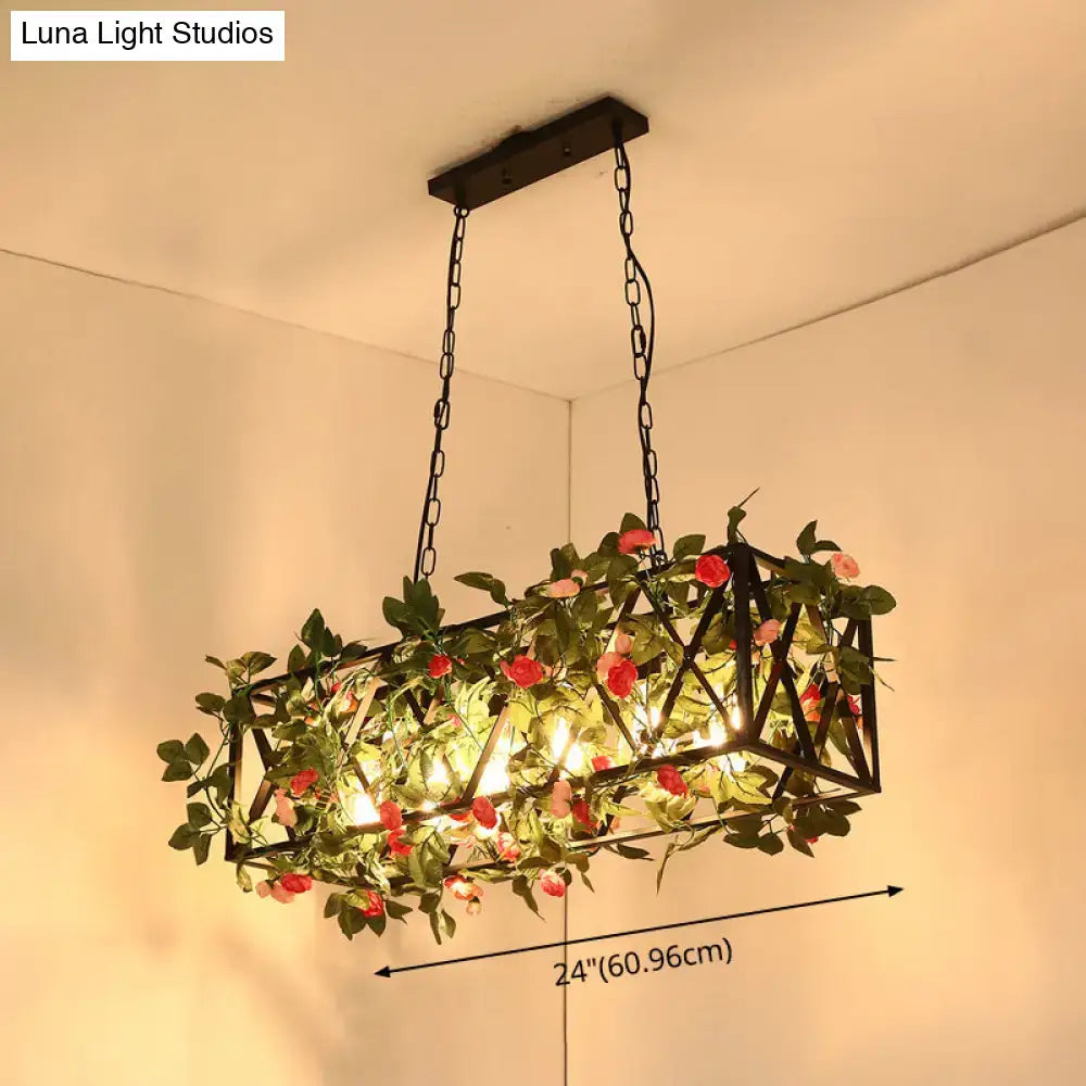 DecorBites™ black retro metal pendant light with rectangular frame, warm glowing lights, and green vines with pink roses