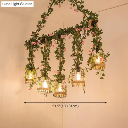 Decorbites™ black retro metal pendant light with five birdcage lights wrapped in ivy and pink flowers for industrial decor