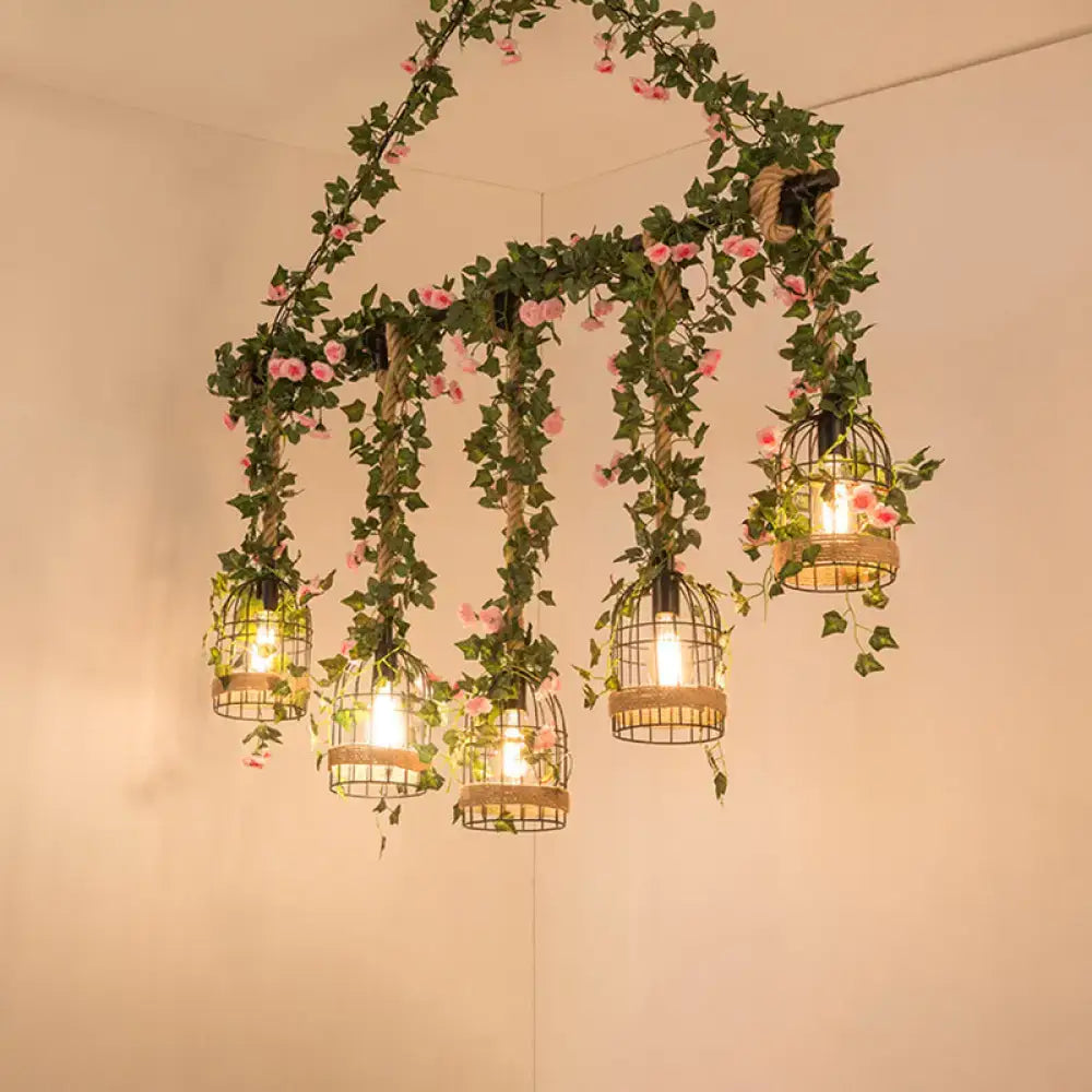 DecorBites black retro metal pendant light with five birdcage lights featuring green ivy and pink flowers