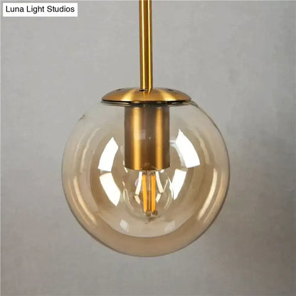 Retro modern glass smoked globe wall lamp with clear glass globe gold hardware and exposed filament bulb for bedroom lighting