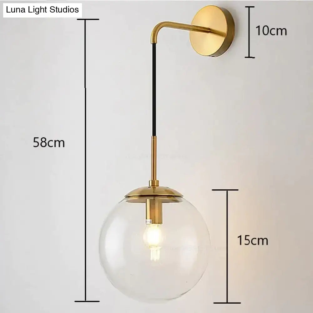 Gold-finished wall lamp with clear glass smoked globe and black accent rod for nordic retro modern bedroom lighting