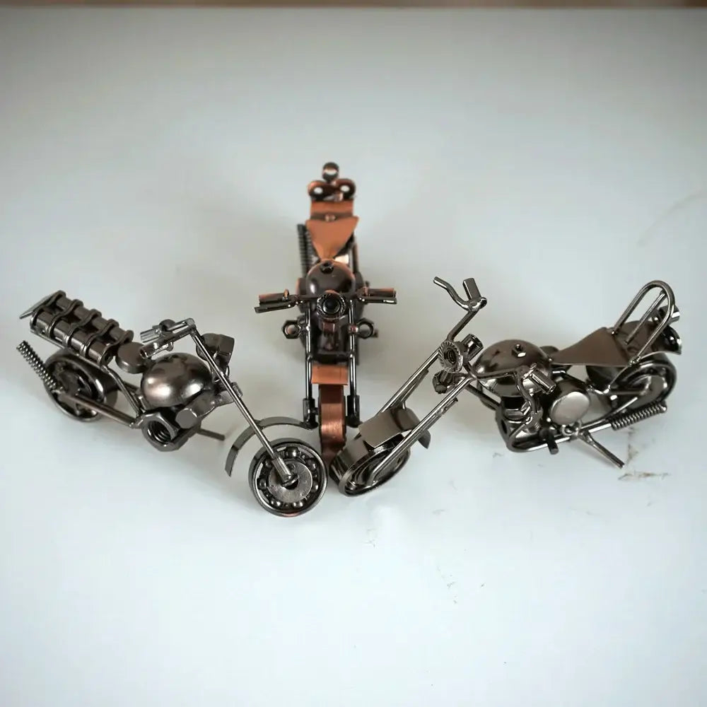 Three dark metallic retro motorcycle model metal figurines with copper leather accents for living room decor