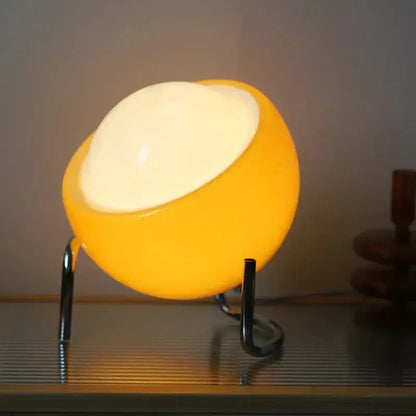 Retro orange decorbites glass table lamp with warm yellow white glow and sleek black metal stand for bedroom decor