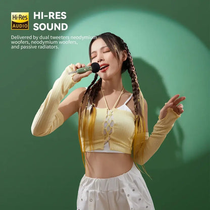 Green handheld microphone with black grille and silver accents for retro pink bluetooth speaker with karaoke sound modes