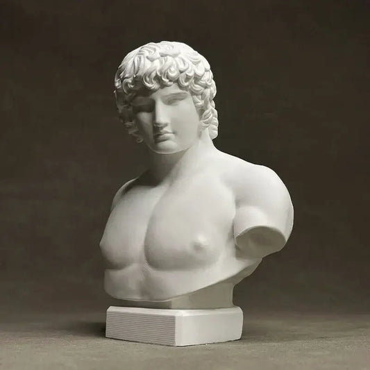 White marble bust of a muscular male figure with curly hair on a rectangular base by decorbites antinous retro plaster sculpture