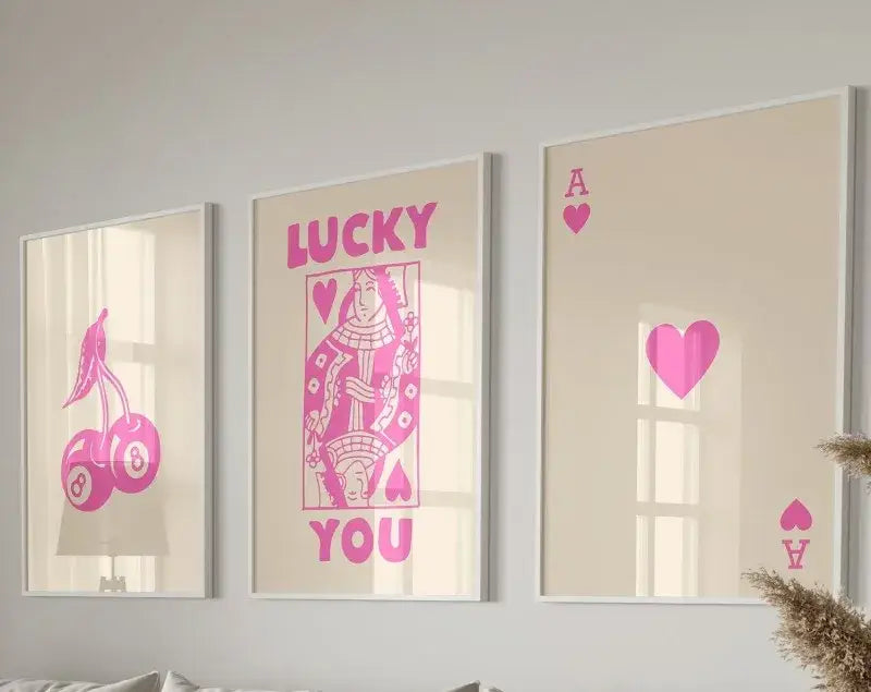 Three framed wall art pieces featuring pink playing card designs on beige background hearts poster set by decorbites