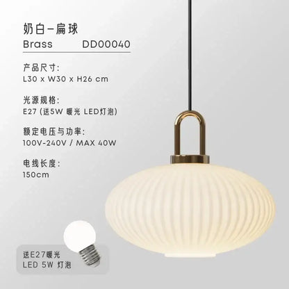 Cream-colored ribbed glass pendant light with a brass fixture ideal for dining room glass pendant lights