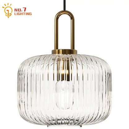 Clear glass pendant light with vertical ridges and brass-finished metal frame for dining room pendant lights