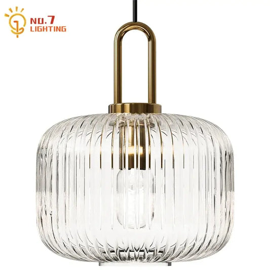 Clear glass pendant light with vertical ridges and brass-finished metal frame for dining room pendant lights